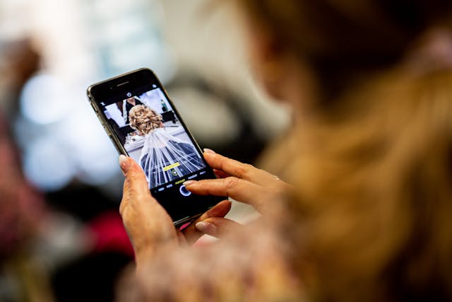 Woman taking selfie with phone, promoting digital products