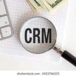 Close-up of text 'CRM' under a magnifying glass.