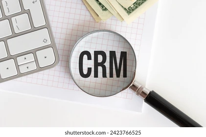 Close-up of text 'CRM' under a magnifying glass.