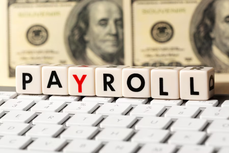 Keyboard with stacked cubes spelling out 'payroll'